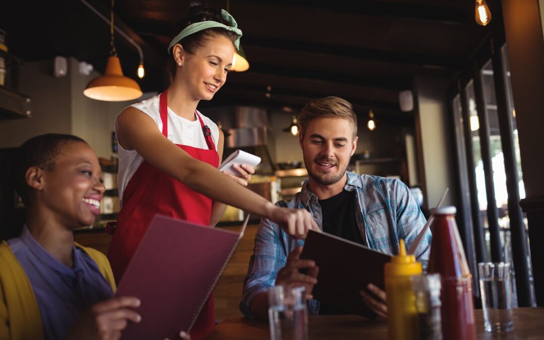 Waitress taking order at restaurant, depicts how to improve guest experience in a restaurant